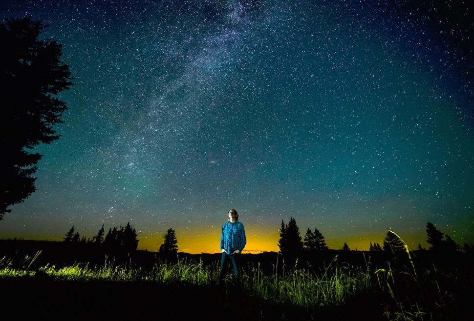 Free Image of Man under starry night sky in a field 