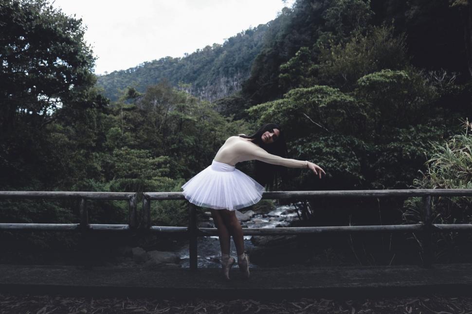 Free Image of Ballerina Posing on a Bridge in Nature 
