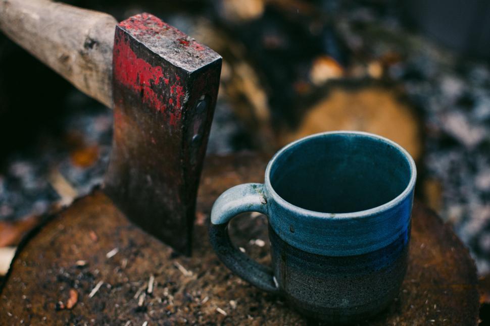 Free Image of Ax and mug on a rustic wood stump 