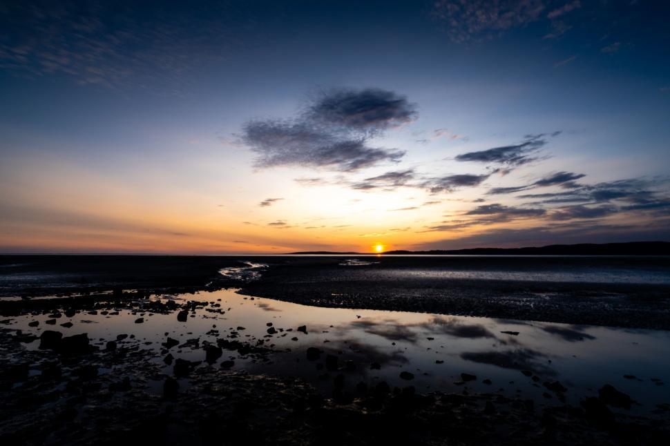 Free Image of Tranquil coastal sunset with reflections 