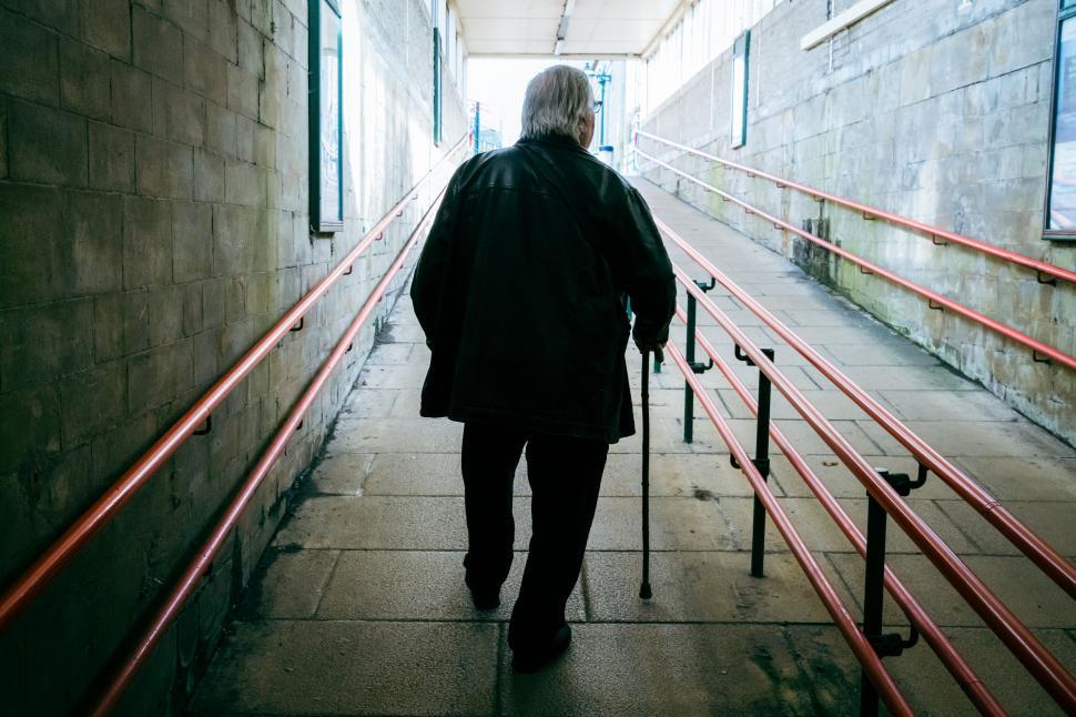 Free Image of Elderly person walking with cane 
