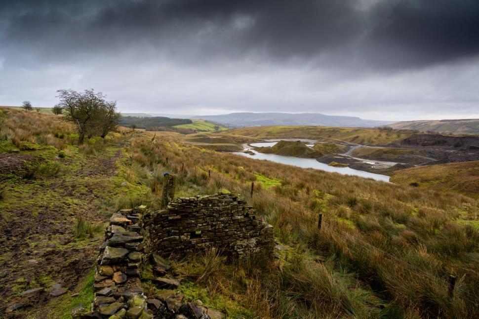 Free Image of Aged ruins overlooking a countryside lake 
