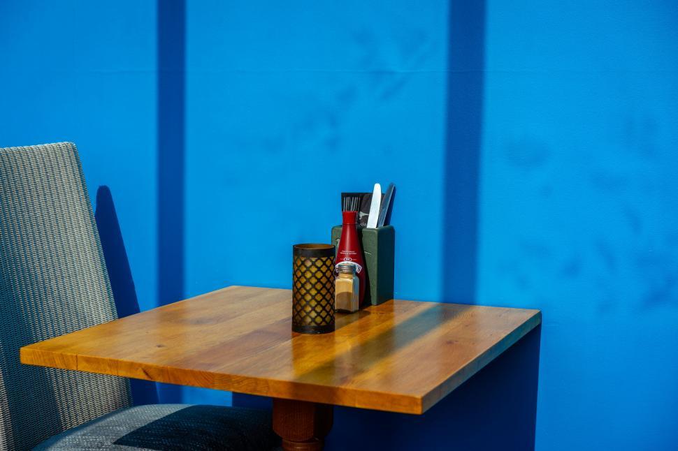 Free Image of Table with condiments against blue wall 