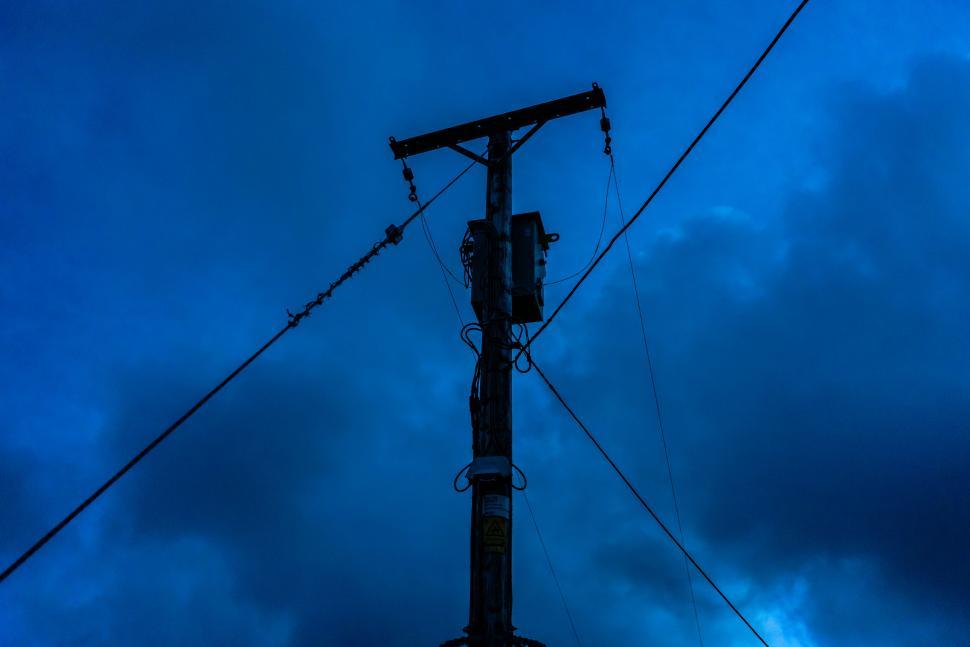 Free Image of Silhouetted power line pole at dusk 