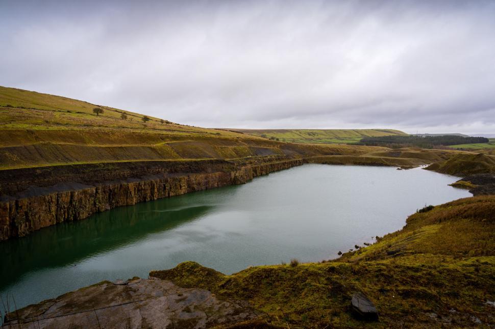 Free Image of Quarry with water against cloudy sky 