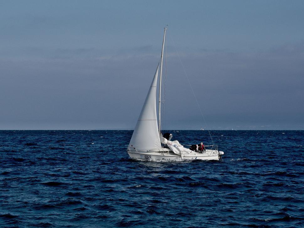 Free Image of Sailboat cruising on a blue sea 