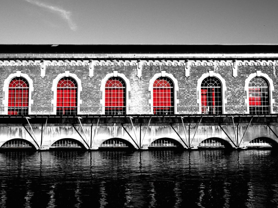 Free Image of Historic building with red windows over water 