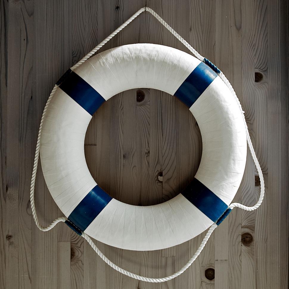 Free Image of White lifebuoy on wooden background 