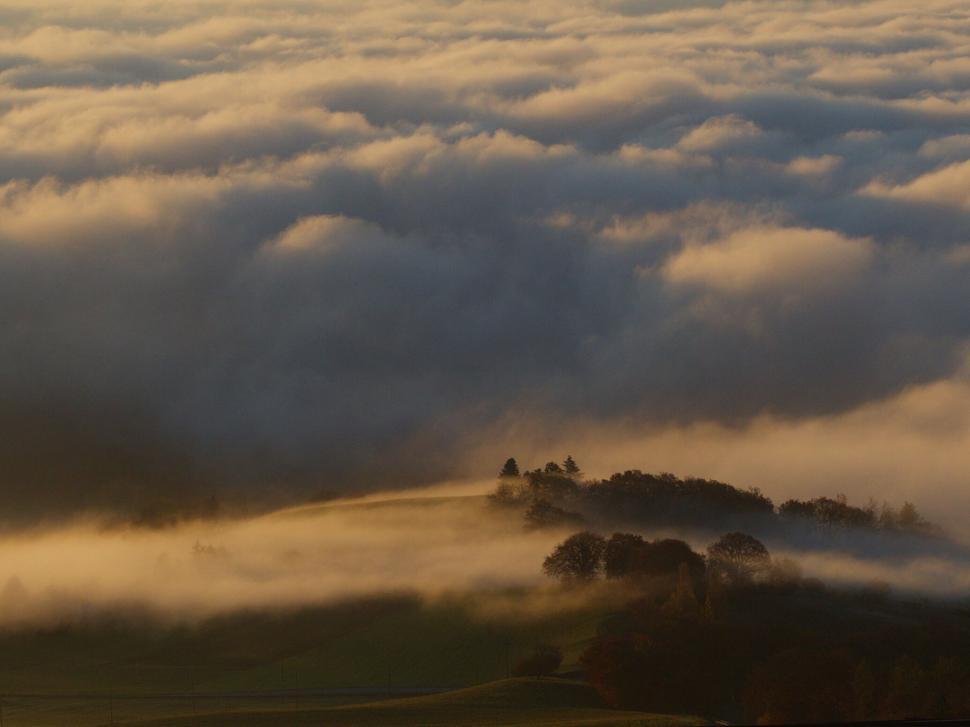 Free Image of Misty hills with sunlight breaking through 