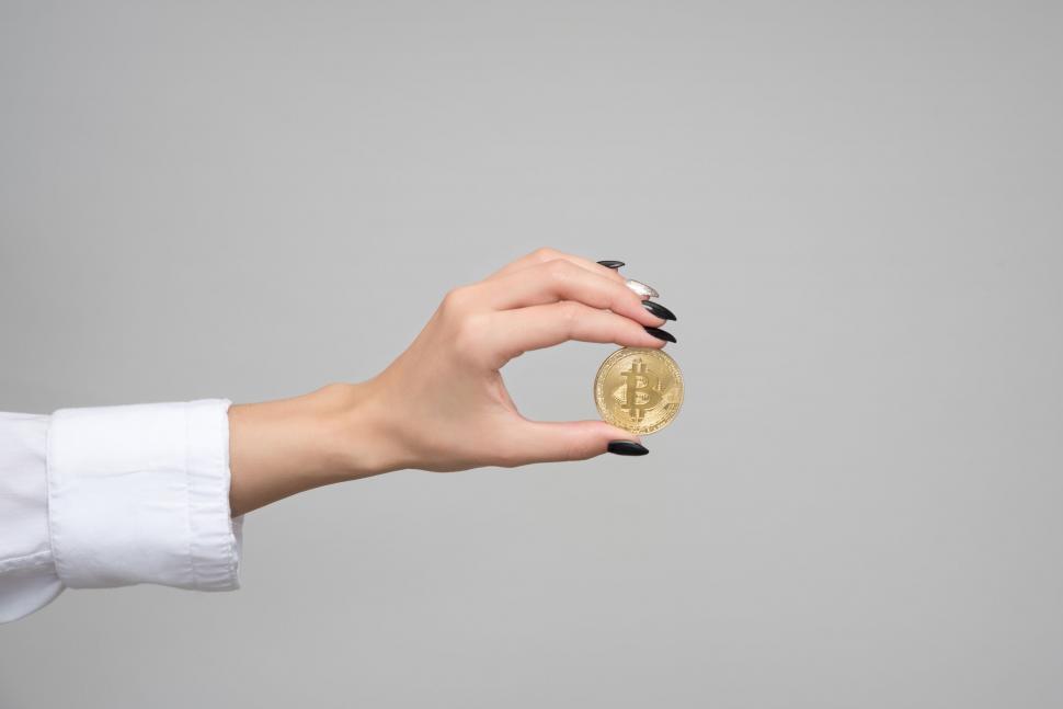 Free Image of Hand holding a Bitcoin, symbolizing cryptocurrency 