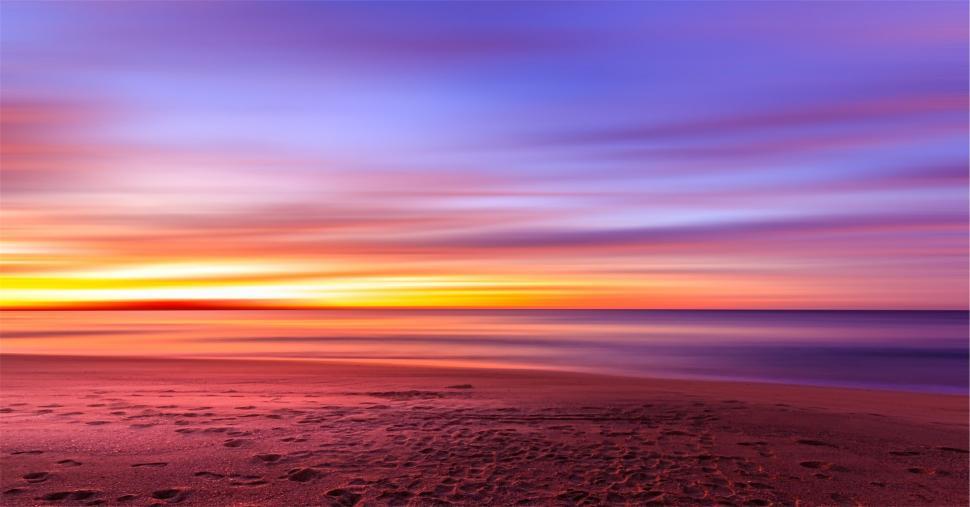 Free Image of Vibrant beach sunset with smooth waves 