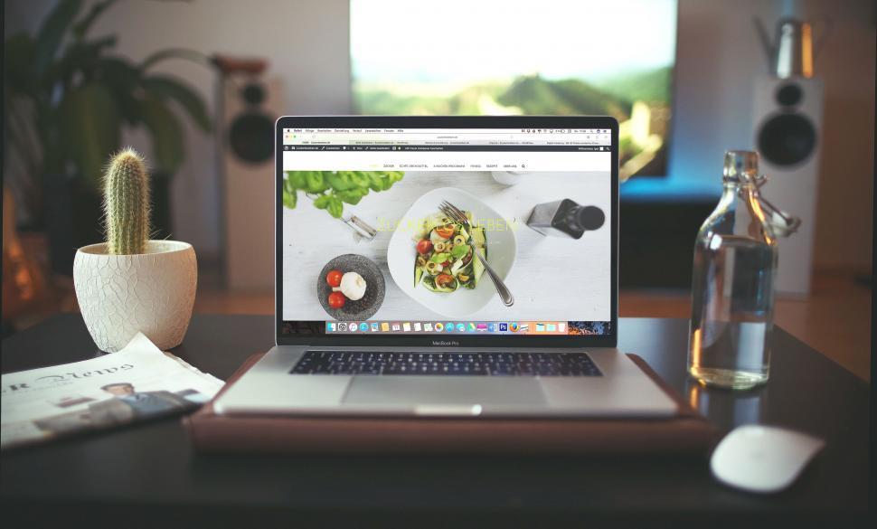 Free Image of Laptop with food blog on screen and accessories 