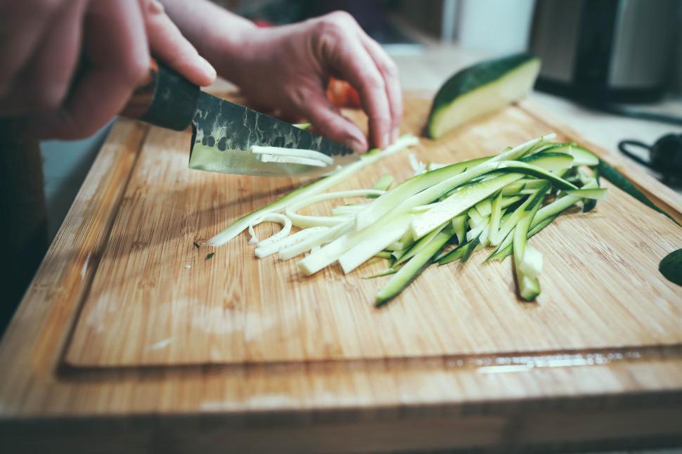 Free Image of Slicing zucchini on a wooden cutting board 