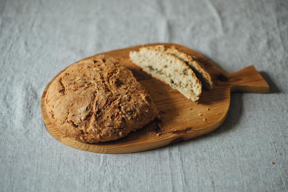 Free Image of Artisan bread on a wooden cutting board 