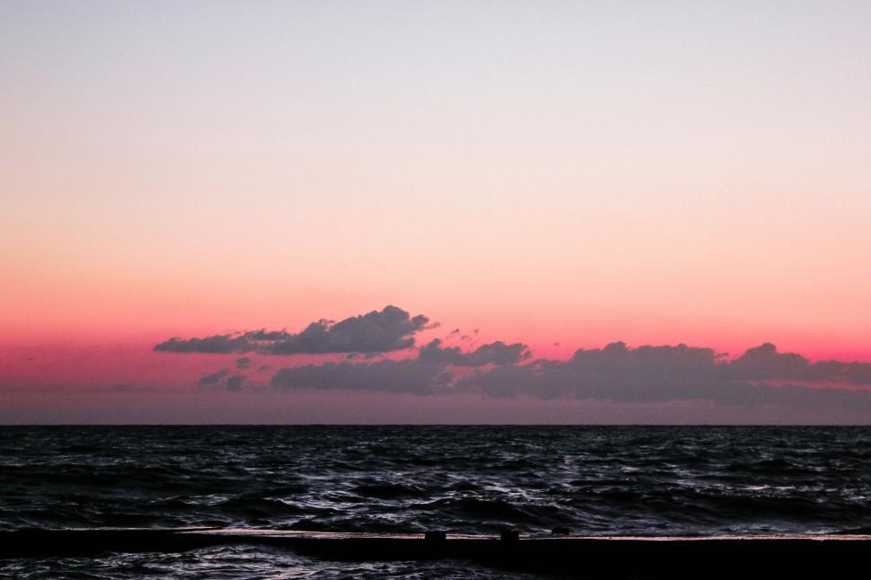 Free Image of Sunset over a turbulent sea 