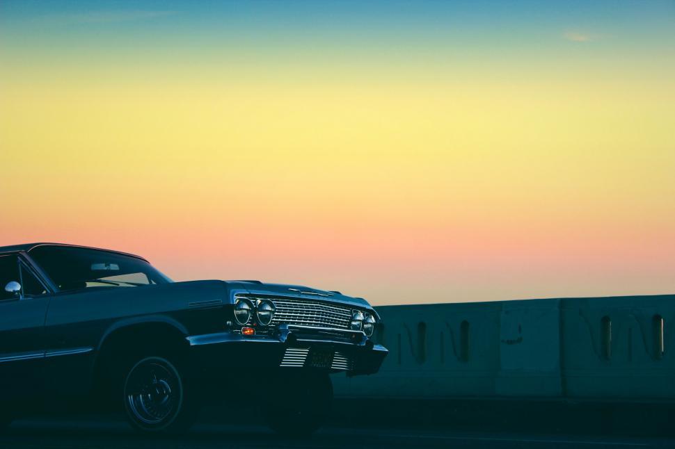 Free Image of Classic car parked at sunset 