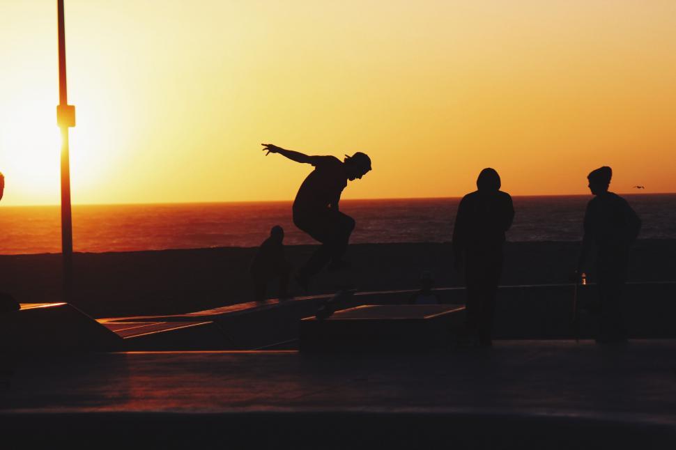 Free Image of Skateboarder silhouette in sunset backdrop 
