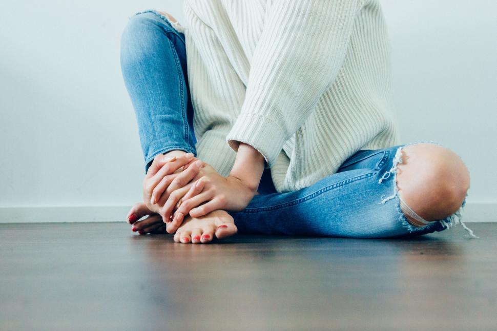 Free Image of Woman in jeans sitting on the floor 
