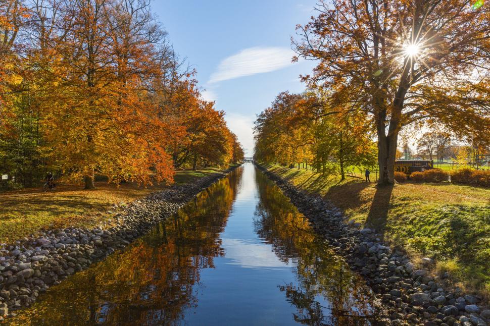 Free Image of Serene autumn day by the waterway 