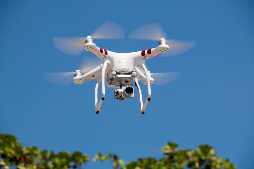 Free Image of Flying drone with camera in blue sky 