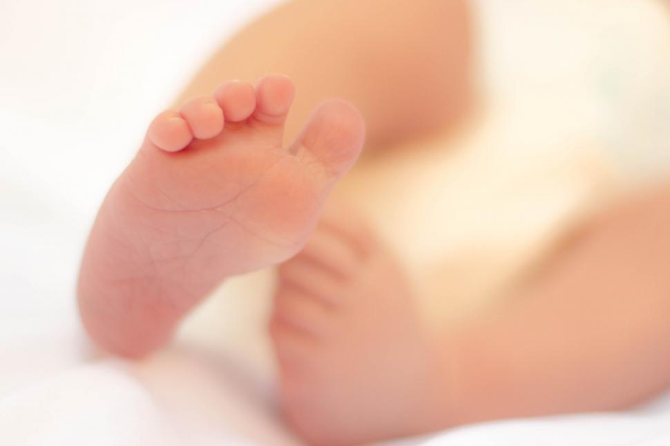 Free Image of Baby s foot in soft focus 