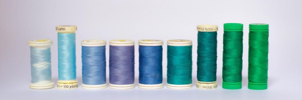 Free Image of Assorted spools of thread on white 