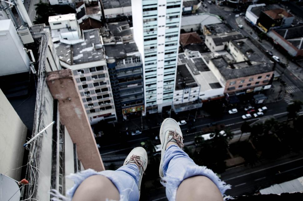 Free Image of Daring urban exploration with feet dangling 