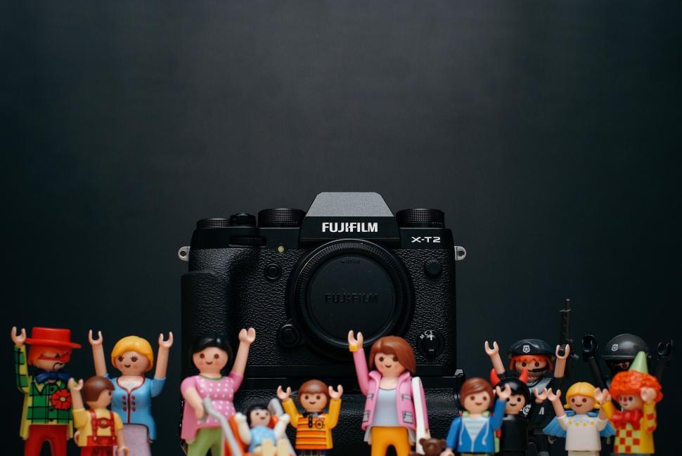 Free Image of Camera and colorful toy figures displayed 