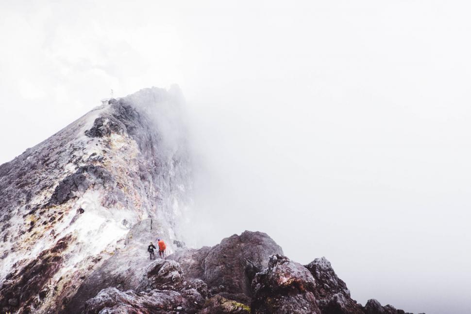Free Image of Climbers ascending foggy volcanic peak 