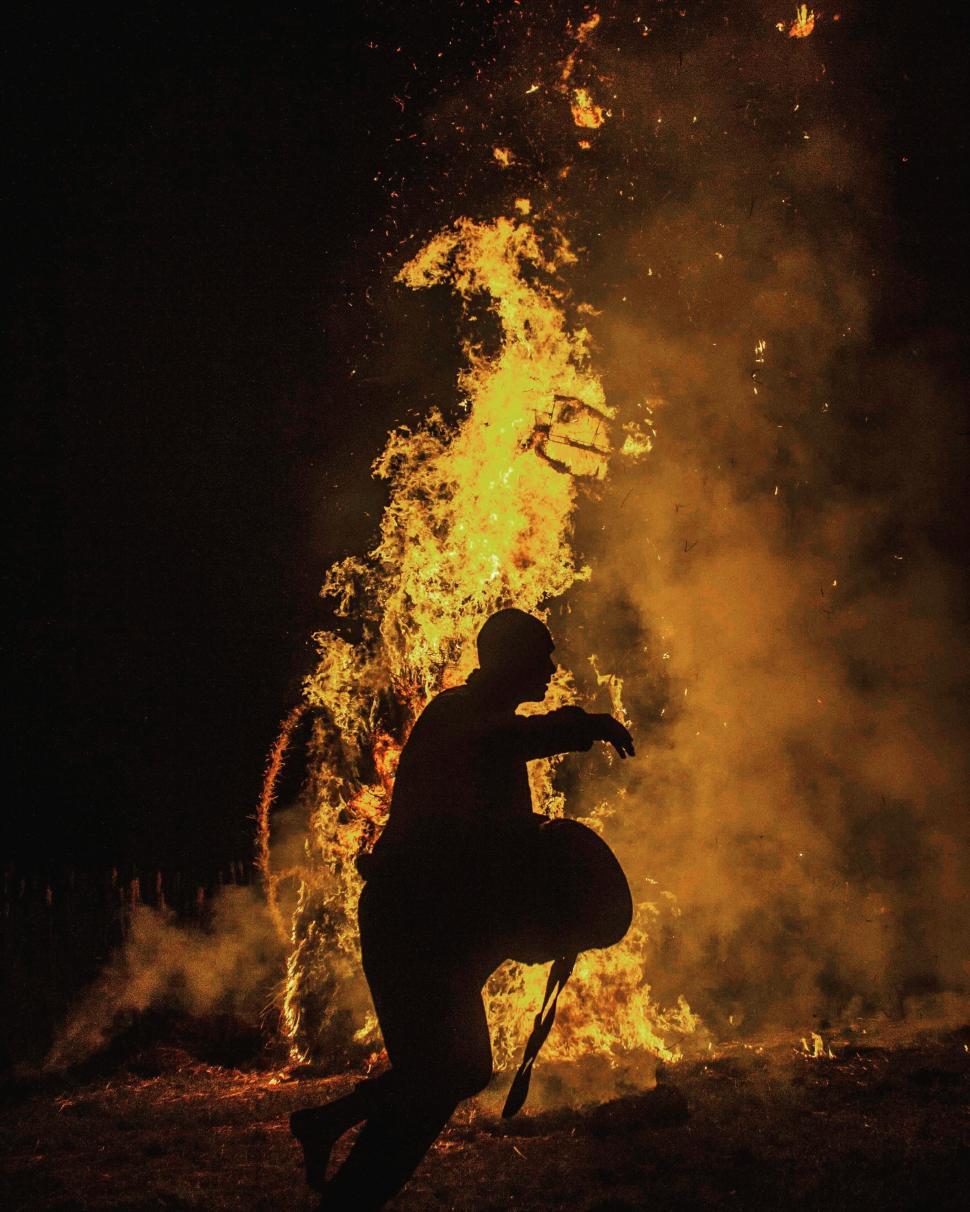 Free Image of Silhouette of person playing with fire 