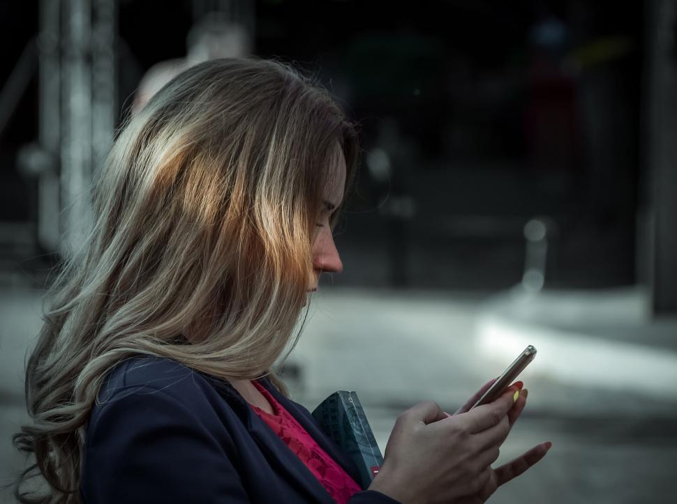 Free Image of Woman using smartphone with blurred face 