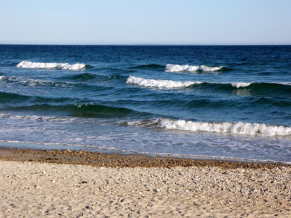 Free Image of Sandy Beach With Waves Rolling Onto Shore 
