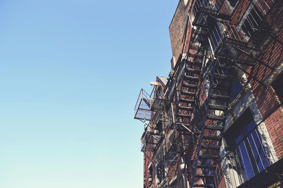 Free Image of Urban brick building with fire escapes 