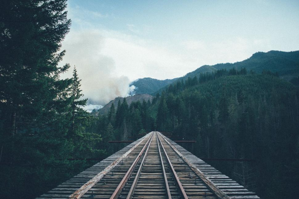 Free Image of Railroad track leading toward a forest fire 