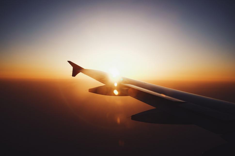 Free Image of Airplane wing against sunset sky 
