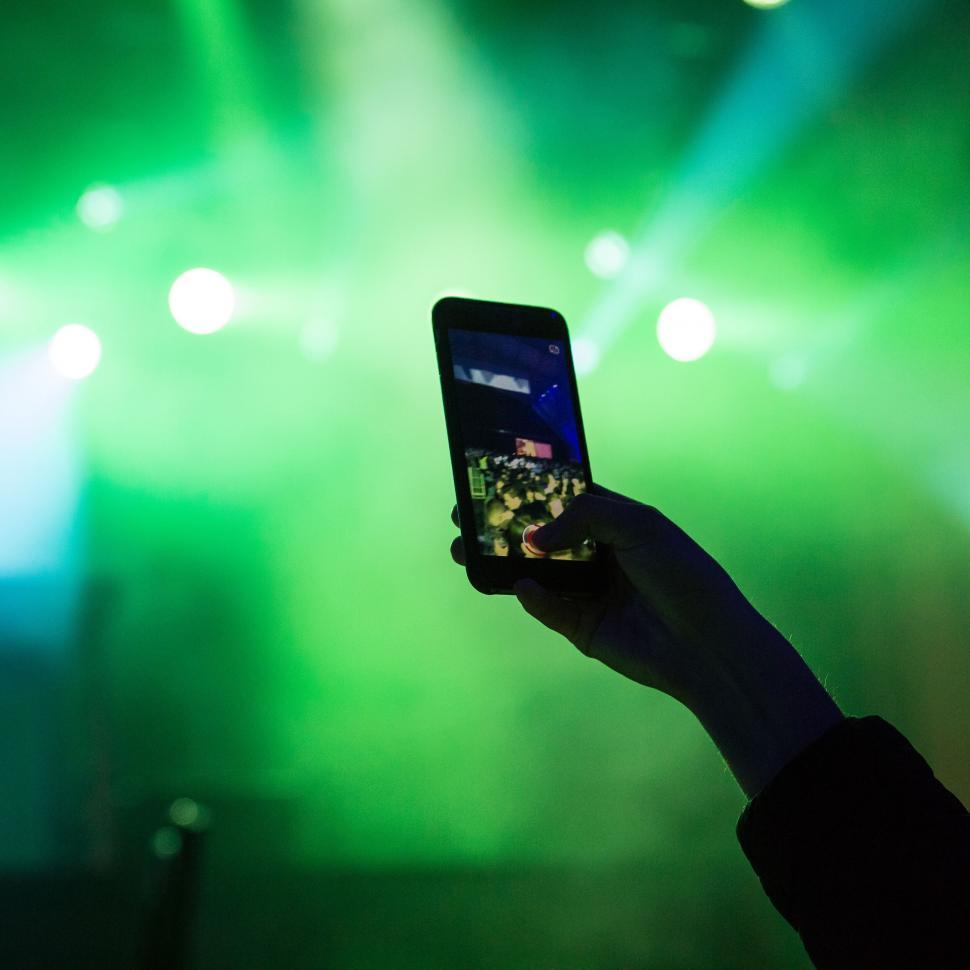 Free Image of Smartphone capturing concert stage 