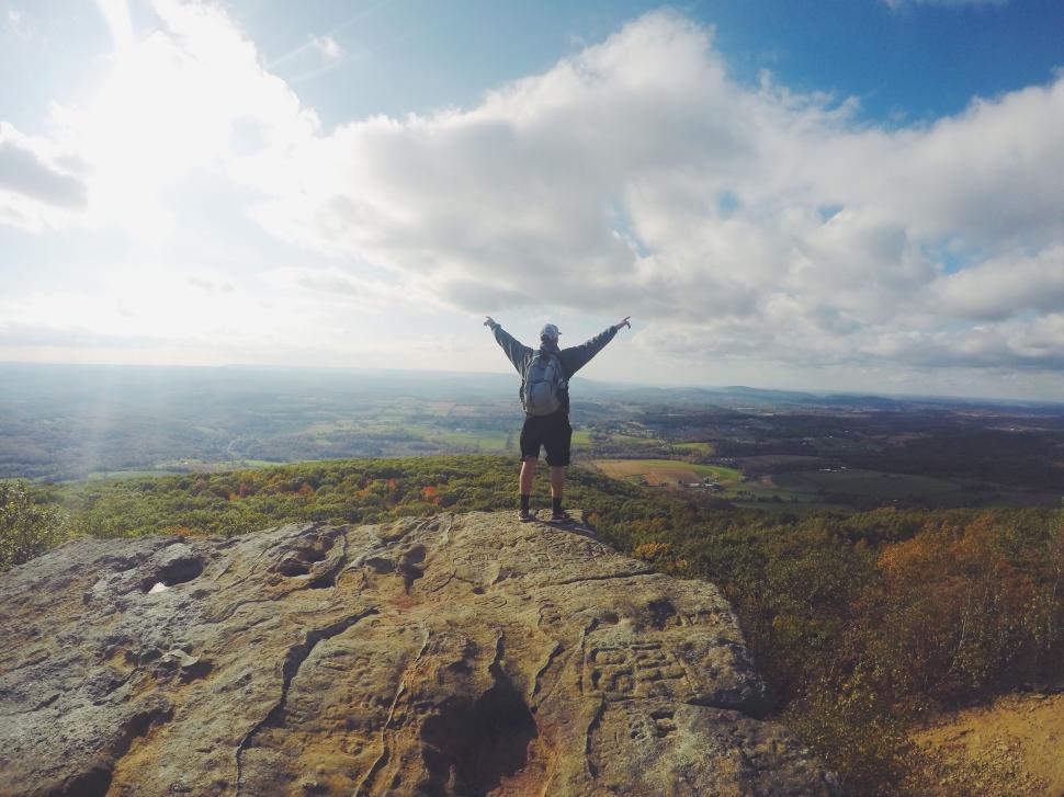 Free Image of Hiker celebrating on mountain top 