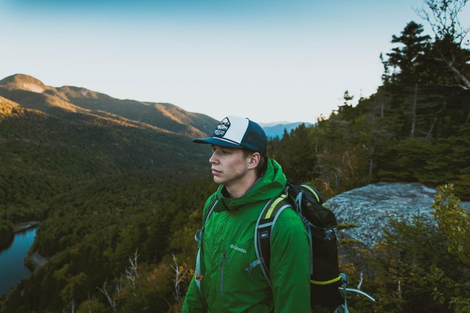 Free Image of Hiker overlooking forested mountains 