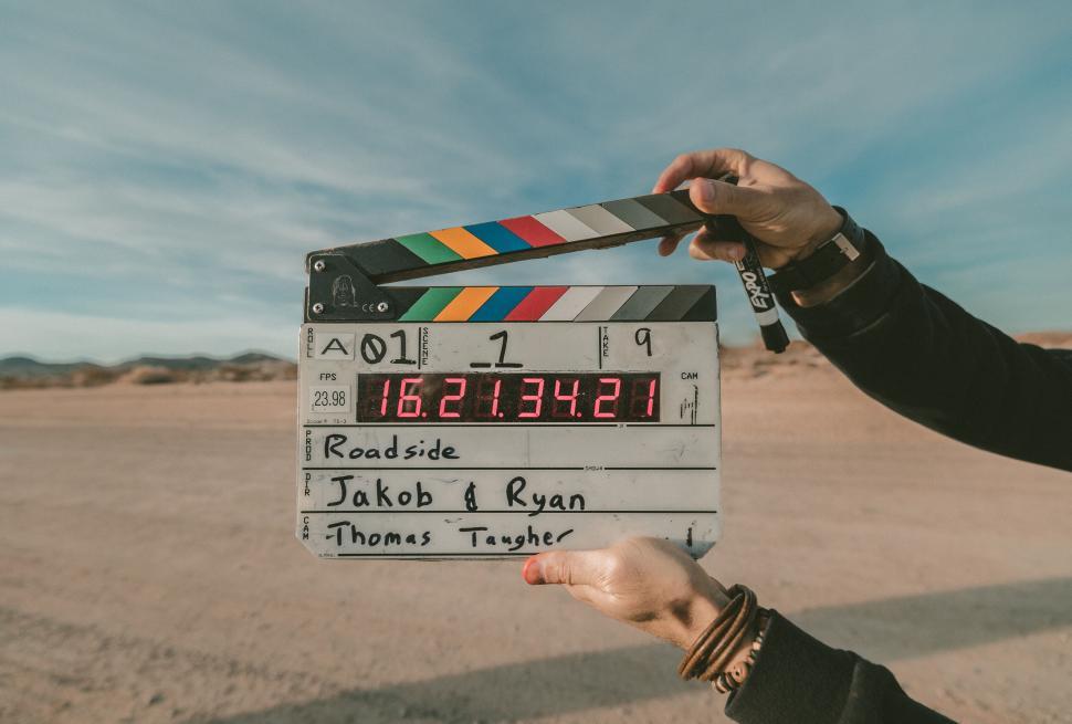 Free Image of Clapperboard in a hand against desert 