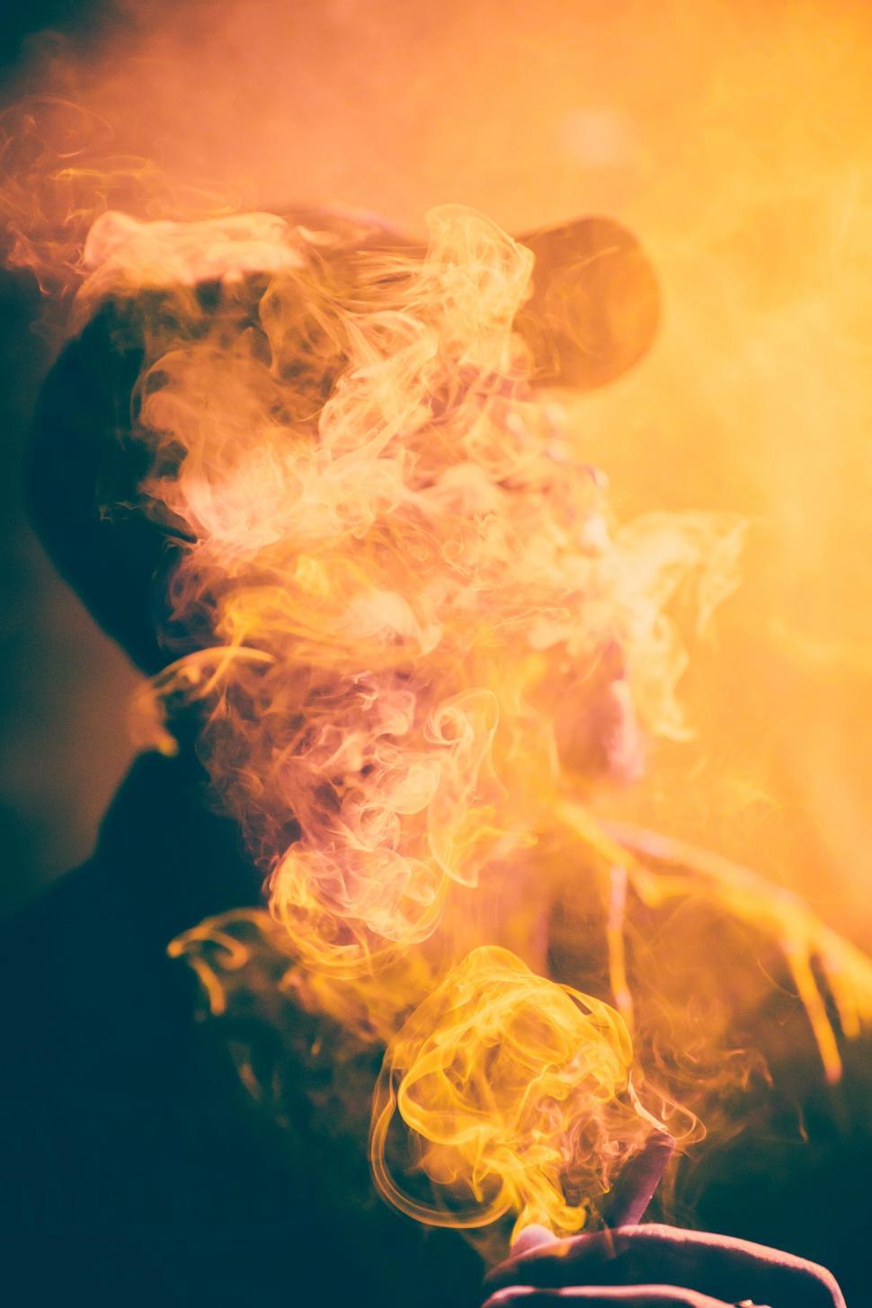 Free Image of Person enveloped in colorful smoke 