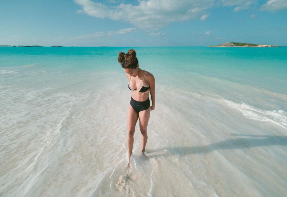 Free Image of Woman wading in tropical shallow waters 