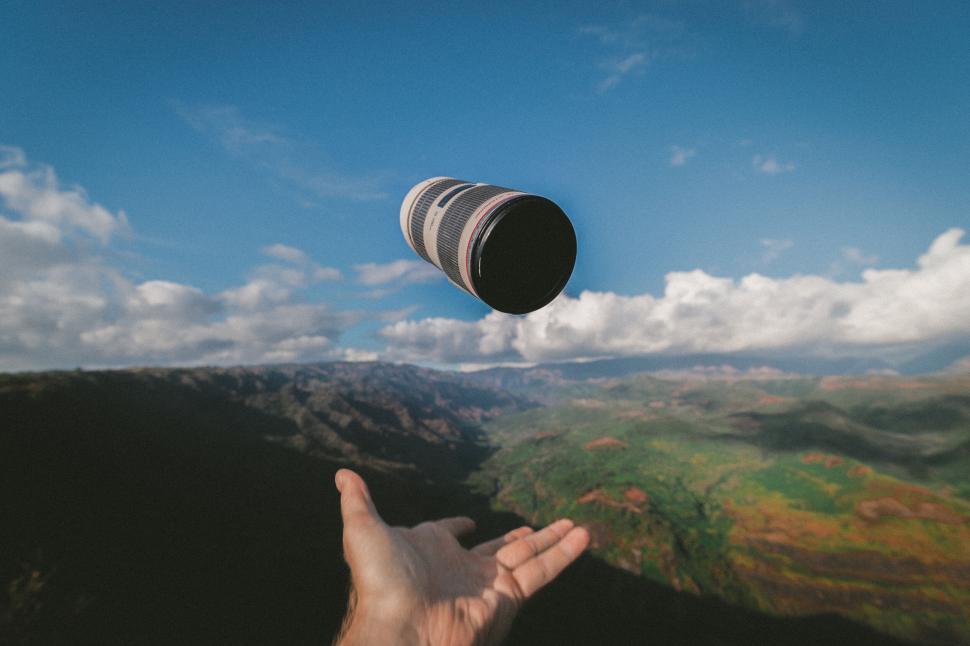 Free Image of Camera lens tossed with scenic backdrop 