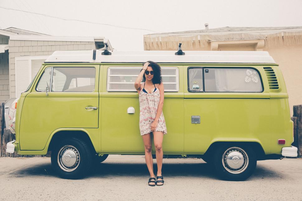 Free Image of Woman standing by a vintage van 