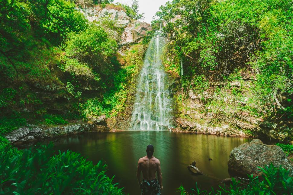 Free Image of Person admiring a serene waterfall 