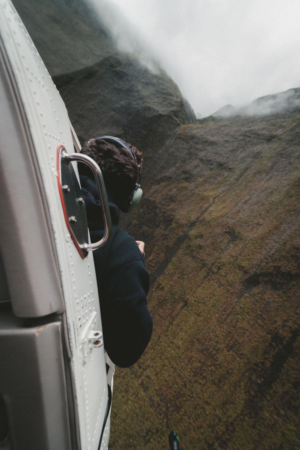 Free Image of Person looking out from helicopter 