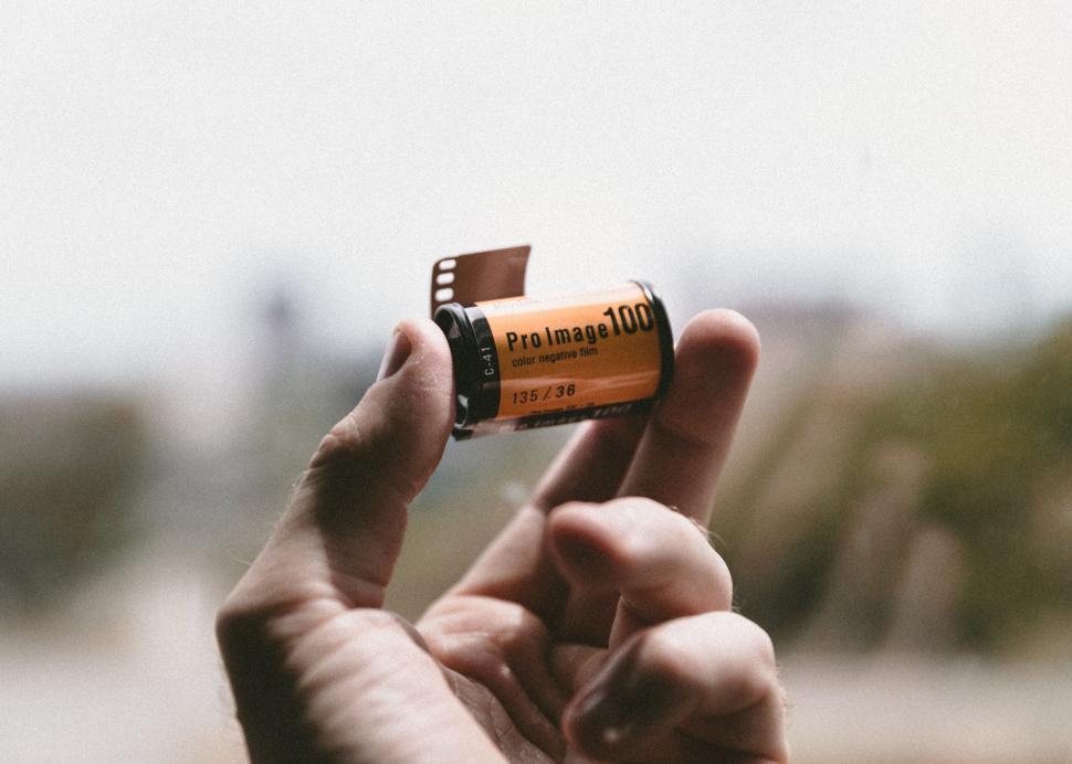 Free Image of Holding a roll of camera film 