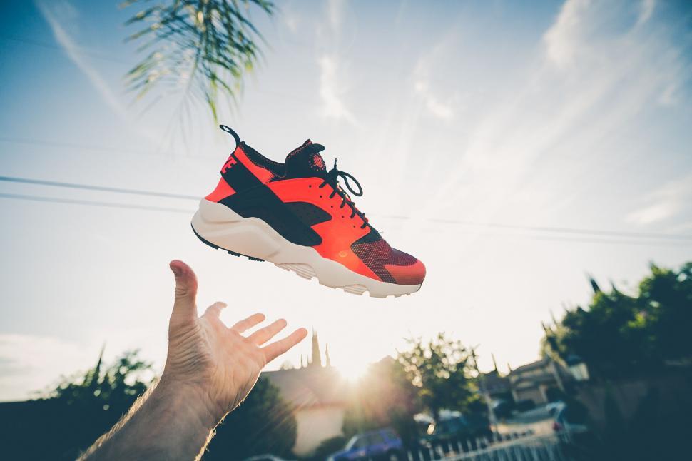 Free Image of Levitating red and black sneaker outdoors 