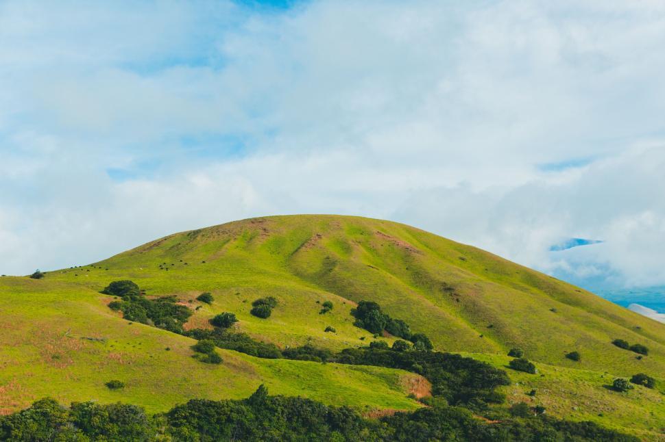 Free Image of Lush Green Hill Under Blue Sky 