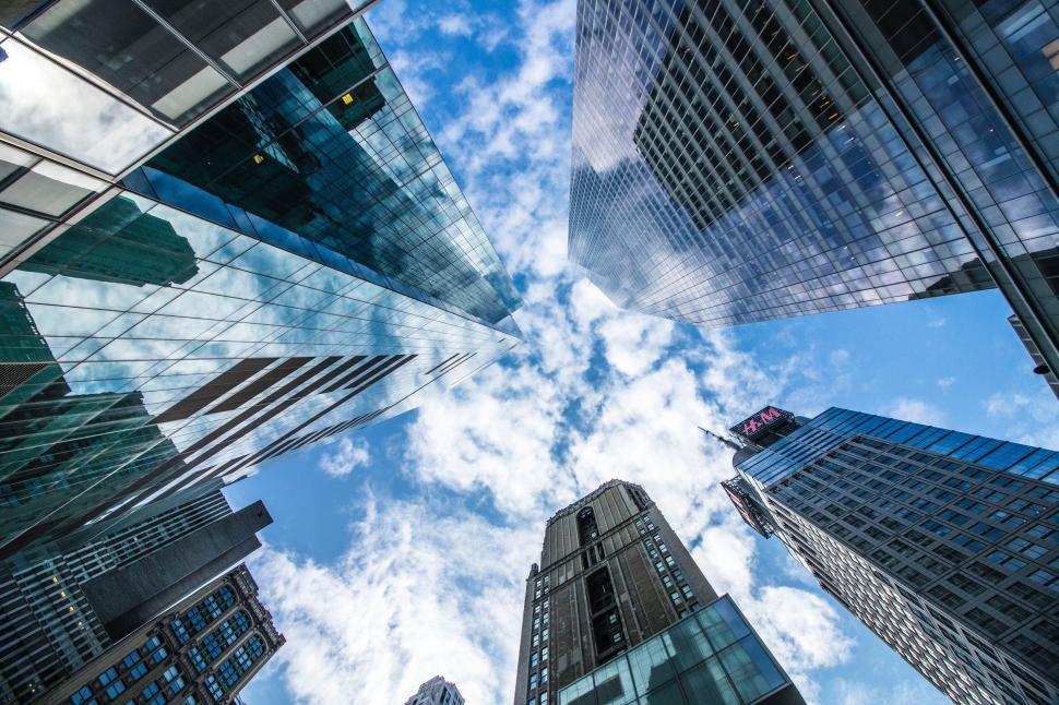Free Image of Looking up at skyscrapers and blue sky 