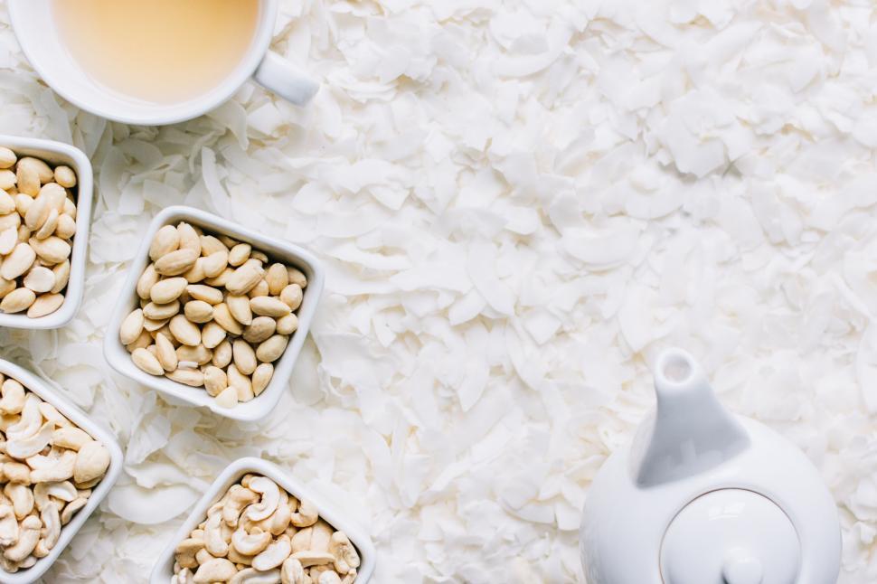 Free Image of Minimalistic tea and cashew snack arrangement 